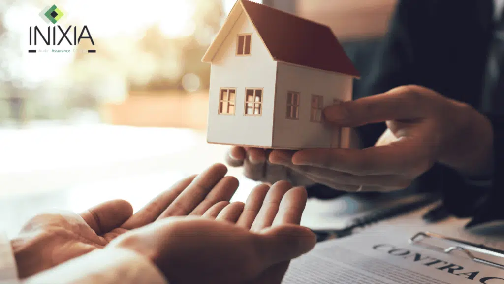 Changer d’assurance emprunteur mode d’emploi - Un personne donne une maquette de maison dans les mains d'une autre personne